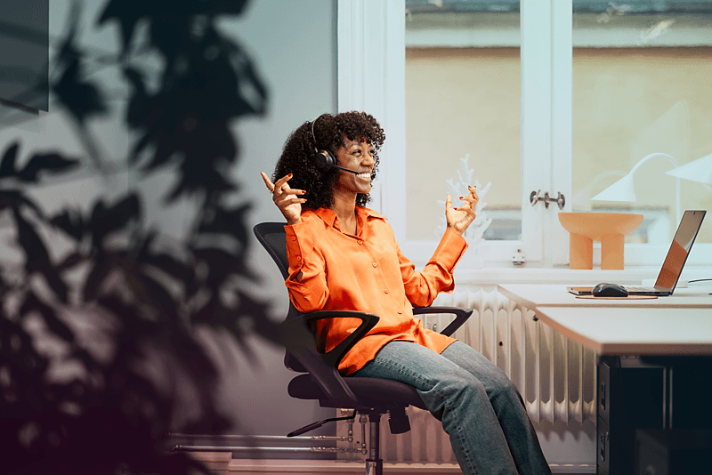 office-woman-black-laptop-headset-talking-smiling-hands-dstnyjpg-1