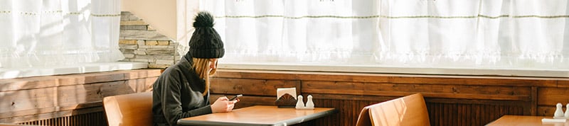 woman with phone in restaurant